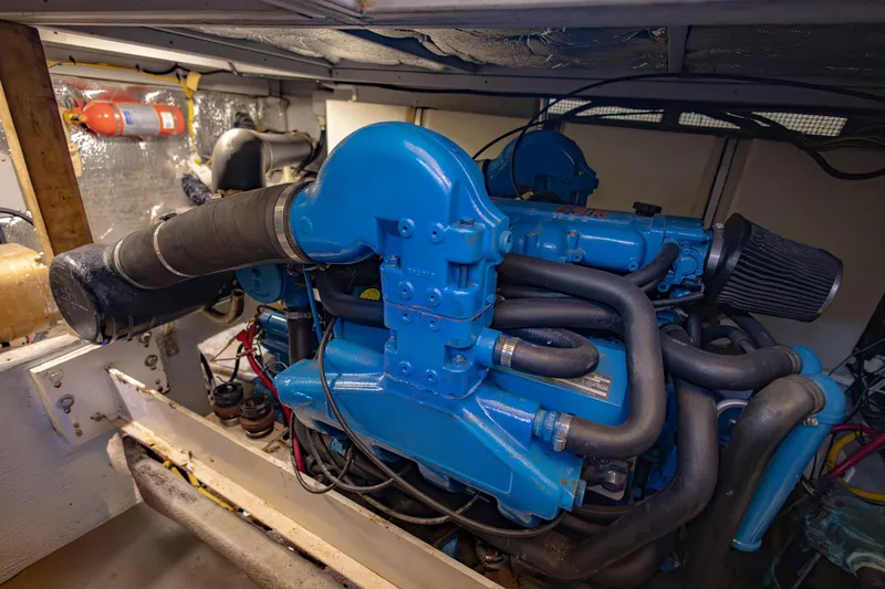 Slide: The Image of Engine room of 2001 Silverton 410 Sport Bridge with blue marine engine. - 60