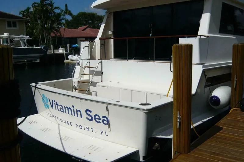 Slide: The Image of 1990 Viking Cockpit Motor Yacht docked, named "Vitamin Sea," Lighthouse Point, FL. - 2