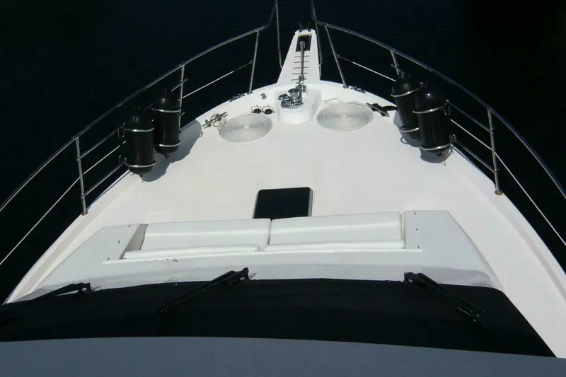 Slide: The Image of 1990 Viking Cockpit Motor Yacht bow view with railings and deck features. - 67
