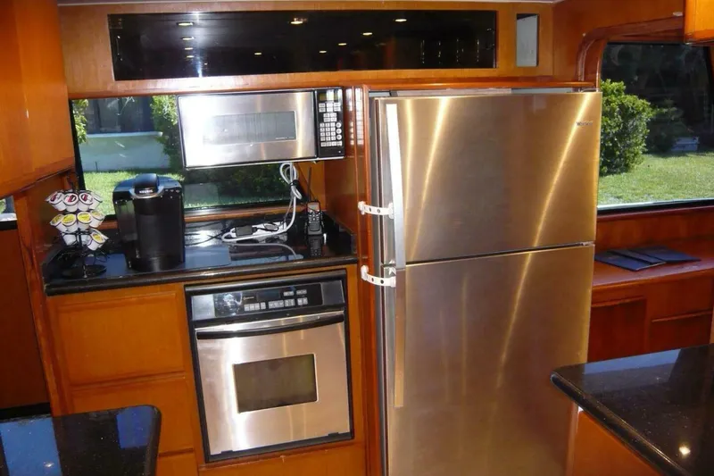 Slide: The Image of Kitchen area of a 1990 Viking Cockpit Motor Yacht with stainless steel appliances. - 19