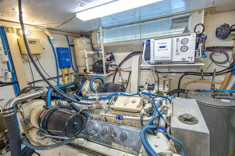 Slide: The Image of Engine room of a 1990 Viking Cockpit Motor Yacht, showcasing complex machinery and equipment. - 78