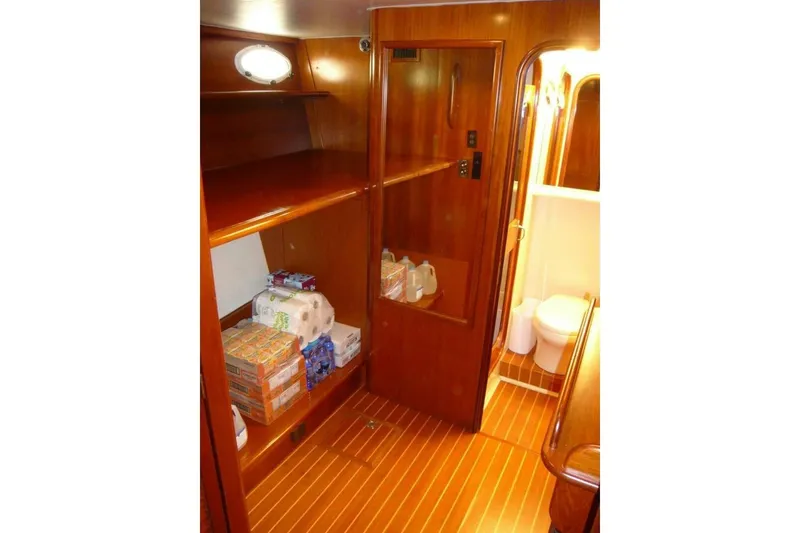 Slide: The Image of Interior of 1990 Viking Cockpit Motor Yacht with wooden cabinetry and stocked shelves. - 44