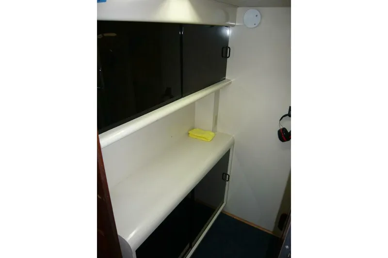 Slide: The Image of Interior storage area of a 1990 Viking Cockpit Motor Yacht with shelves and cabinets. - 45