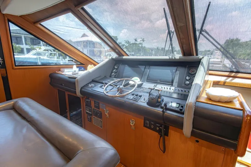 Slide: The Image of Cockpit of a 1990 Viking Motor Yacht with steering wheel and control panel. - 20