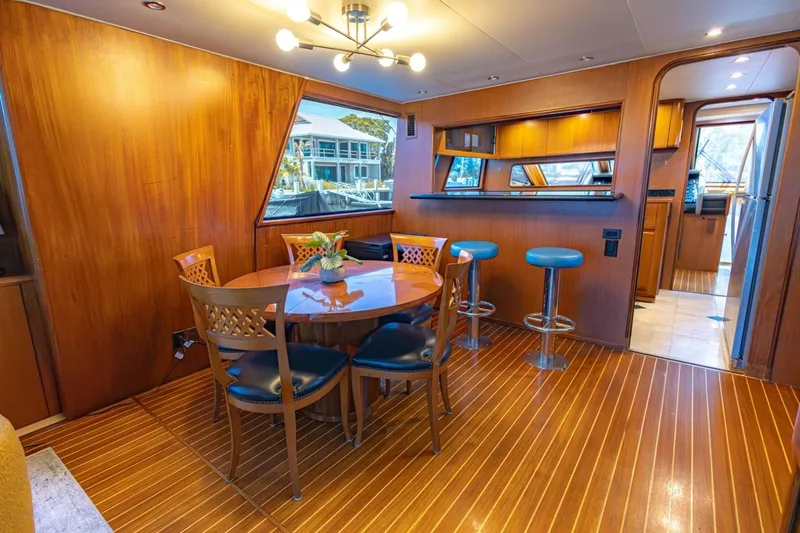 Slide: The Image of Luxurious 1990 Viking Cockpit Motor Yacht interior with elegant dining area and bar stools. - 15
