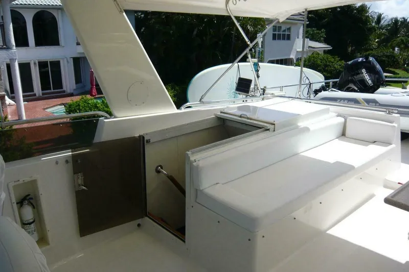 Slide: The Image of 1990 Viking Cockpit Motor Yacht interior with white seating and outdoor view. - 64