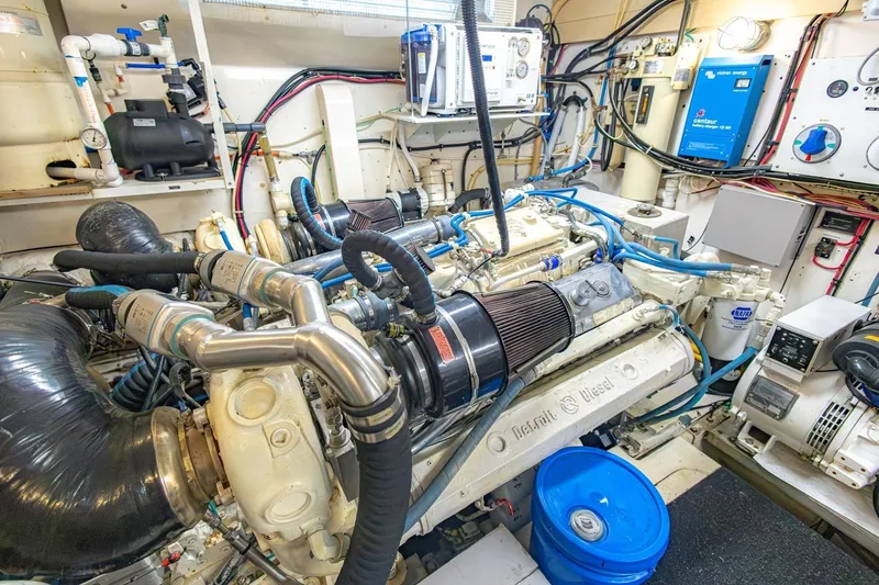 Slide: The Image of Engine room of a 1990 Viking Cockpit Motor Yacht, showcasing diesel engines and mechanical systems. - 75