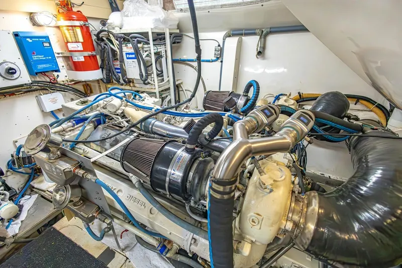 Slide: The Image of Engine room of a 1990 Viking Cockpit Motor Yacht with visible machinery and equipment. - 76