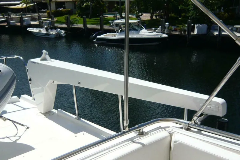 Slide: The Image of 1990 Viking Cockpit Motor Yacht docked, featuring sleek white design and polished railings. - 65