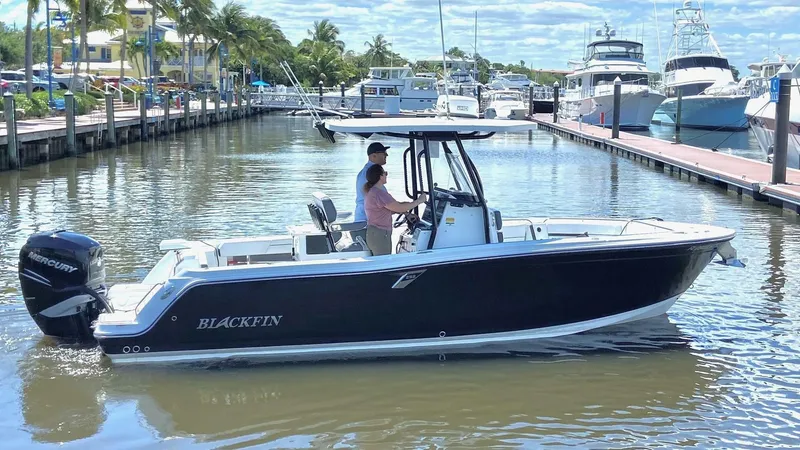The Image of 2021 Blackfin 252 boat cruising in a marina with two people onboard. - 0