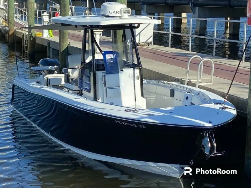 Slide: The Image of 2021 Blackfin 252 boat docked at marina, featuring sleek design and modern equipment. - 1