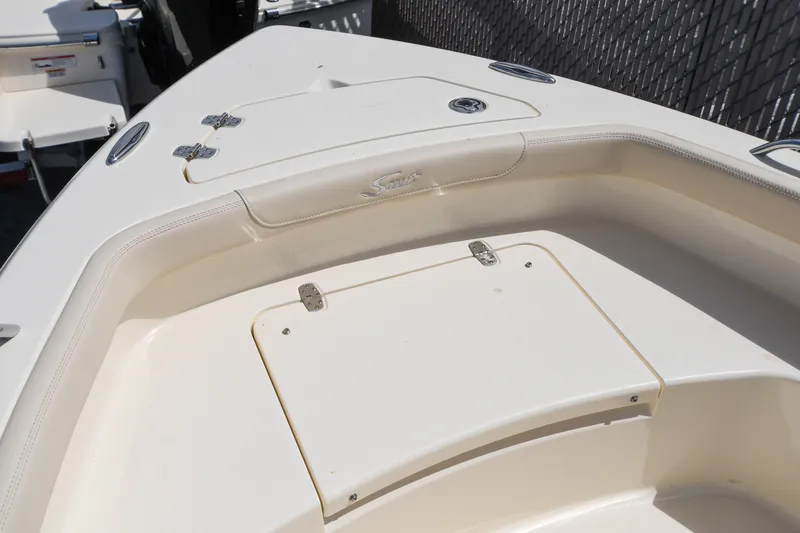 Slide: The Image of 2026 Scout 188 Sportfish boat interior with storage compartments and sleek design. - 2