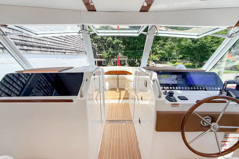 Slide: The Image of Helm of 2027 MJM 38 X boat with modern navigation equipment and wooden accents. - 35