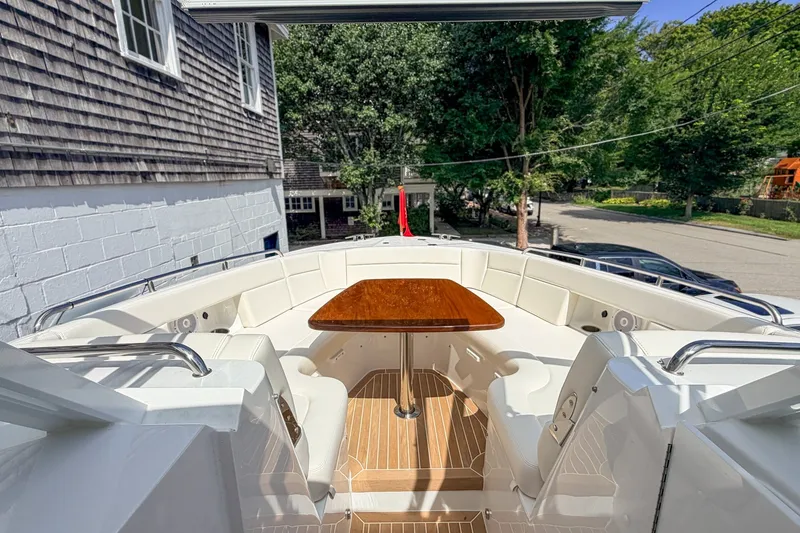 Slide: The Image of Luxurious seating area on 2027 MJM 38 X boat with wooden table and white cushions. - 34