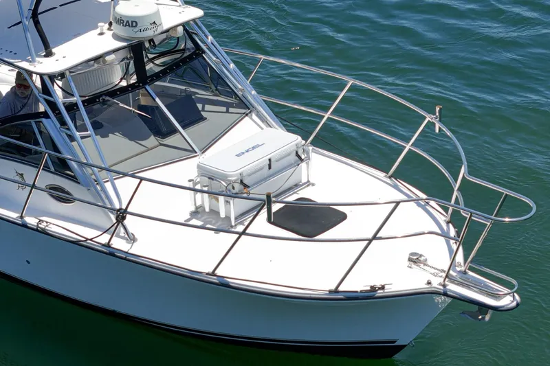 Slide: The Image of 1999 Albemarle 290 Express Fisherman boat on water, featuring sleek design and sturdy railings. - 12