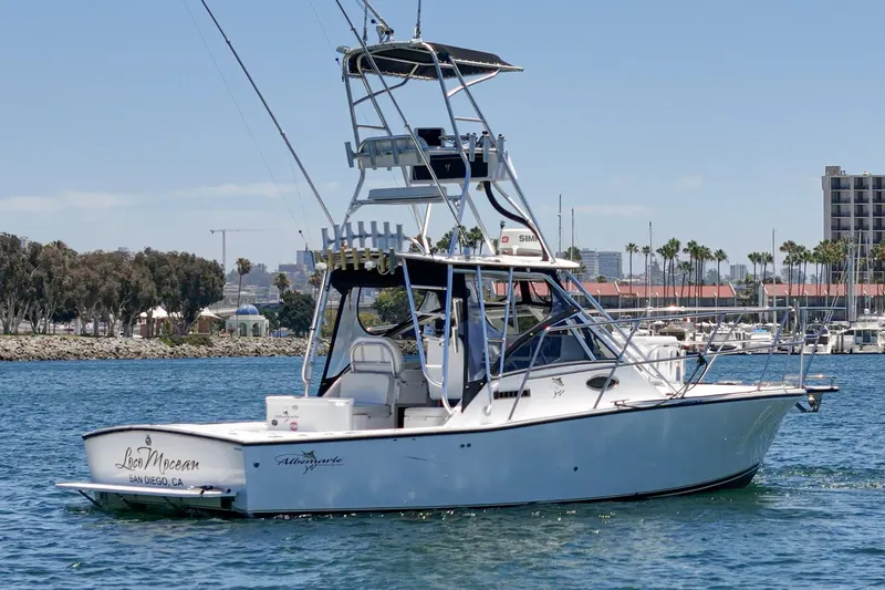 Slide: The Image of 1999 Albemarle 290 Express Fisherman boat on water near marina. - 2