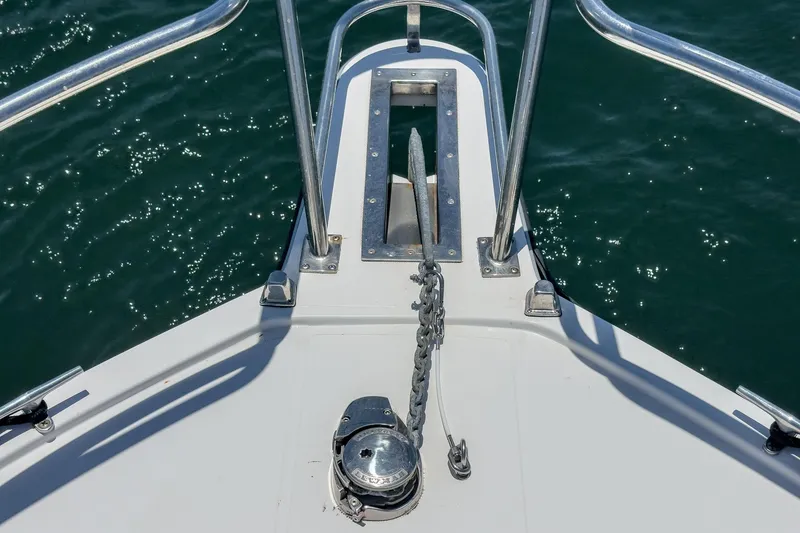 Slide: The Image of Bow of 1999 Albemarle 290 Express Fisherman with anchor and chain over water. - 22