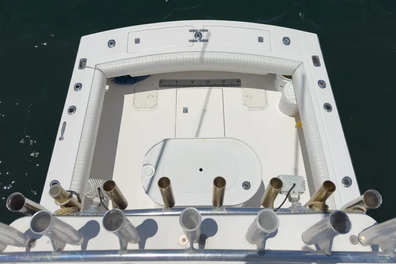 Slide: The Image of 1999 Albemarle 290 Express Fisherman boat deck with rod holders and measuring ruler. - 26