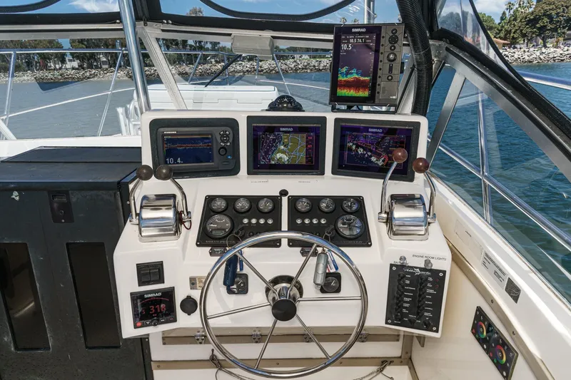 Slide: The Image of 1999 Albemarle 290 Express Fisherman helm with navigation screens and controls. - 35