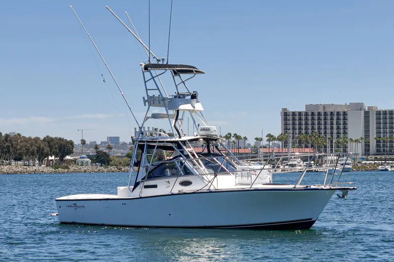 Slide: The Image of 1999 Albemarle 290 Express Fisherman boat on water, with cityscape background. - 4