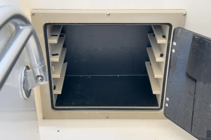 Slide: The Image of Open storage compartment on a 1999 Albemarle 290 Express Fisherman boat. - 46