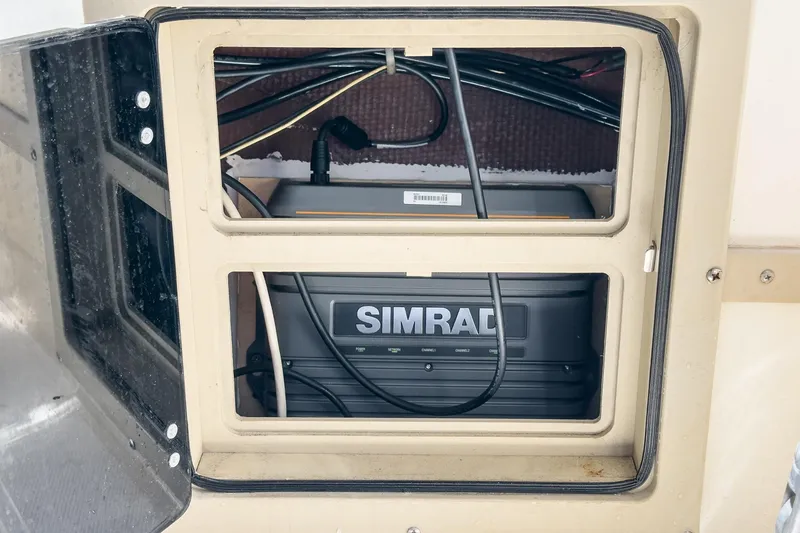 Slide: The Image of Simrad electronic equipment installed in a 1999 Albemarle 290 Express Fisherman boat compartment. - 47