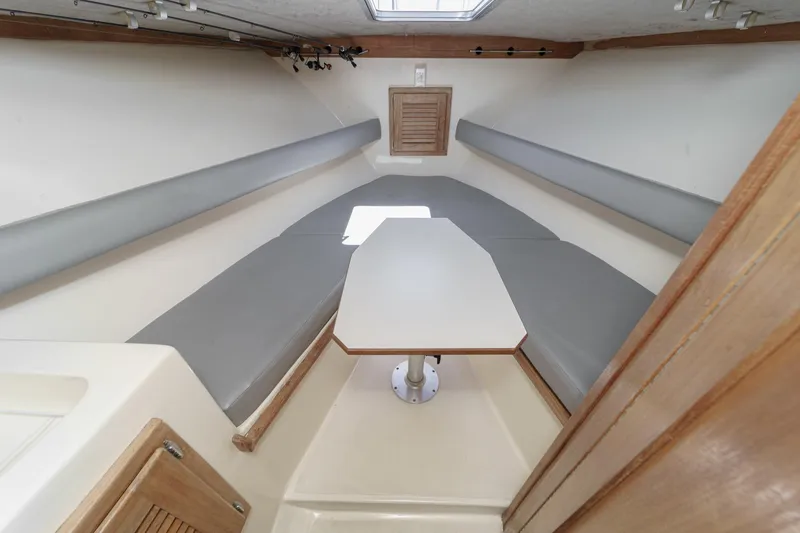 Slide: The Image of 1999 Albemarle 290 Express Fisherman cabin interior with seating and table. - 49