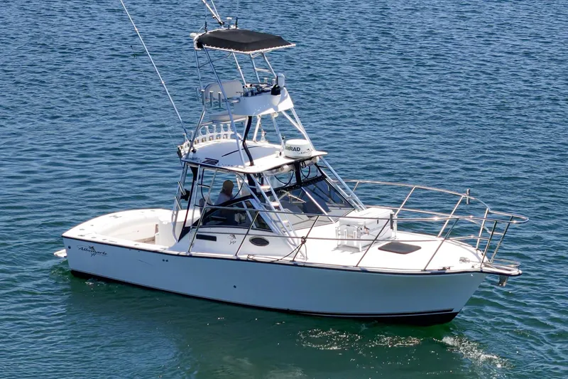 Slide: The Image of 1999 Albemarle 290 Express Fisherman boat cruising on clear blue water. - 5