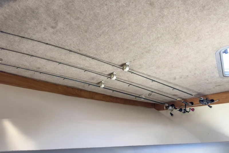 Slide: The Image of Fishing rods stored on the ceiling of a 1999 Albemarle 290 Express Fisherman boat. - 52