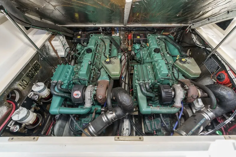 Slide: The Image of Engine compartment of a 1999 Albemarle 290 Express Fisherman, showcasing dual marine engines. - 59