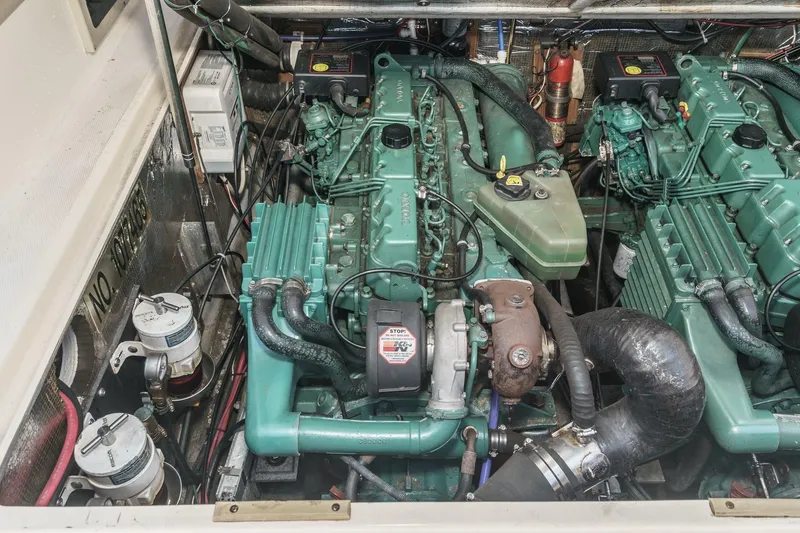 Slide: The Image of Engine compartment of a 1999 Albemarle 290 Express Fisherman boat, showcasing dual engines. - 62