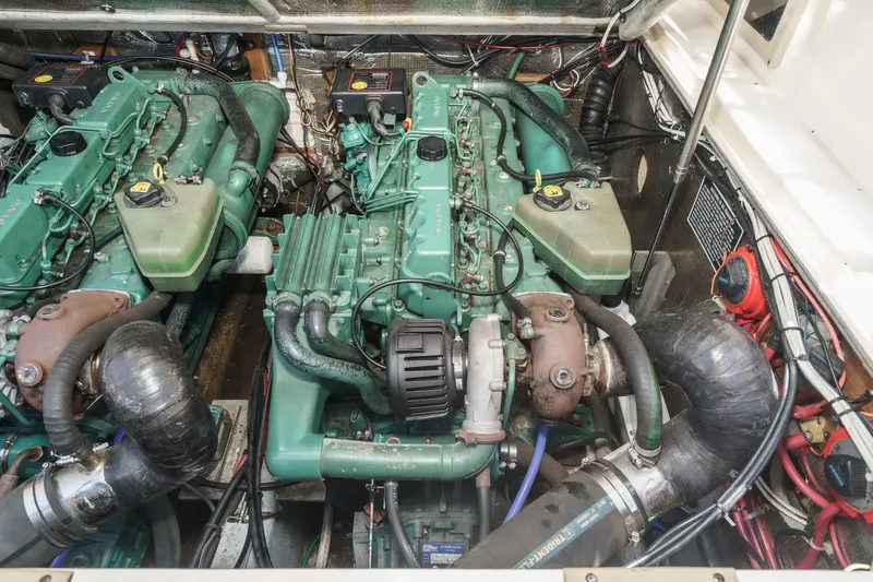 Slide: The Image of Engine compartment of a 1999 Albemarle 290 Express Fisherman boat, showcasing dual engines. - 63