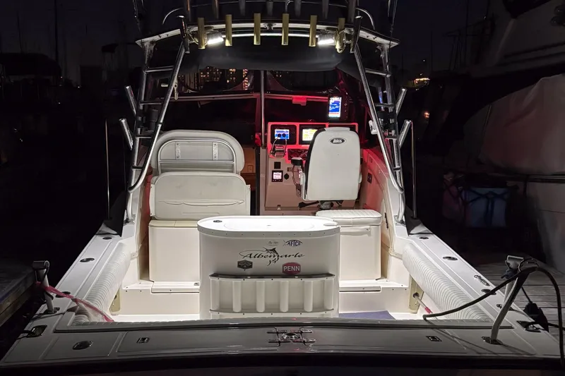 Slide: The Image of 1999 Albemarle 290 Express Fisherman boat interior with illuminated dashboard and fishing equipment. - 66