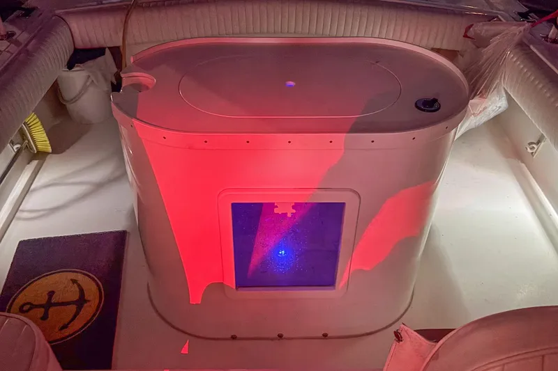 Slide: The Image of 1999 Albemarle 290 Express Fisherman boat interior with red lighting and seating. - 68