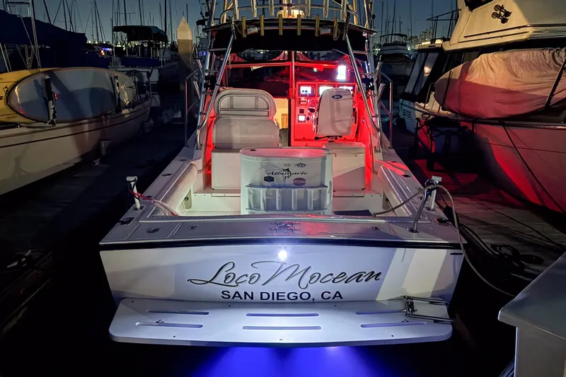 Slide: The Image of 1999 Albemarle 290 Express Fisherman boat docked at night, illuminated with red and blue lights. - 69