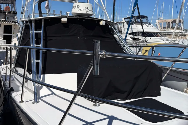 Slide: The Image of 1999 Albemarle 290 Express Fisherman boat docked, featuring sleek design and radar equipment. - 70
