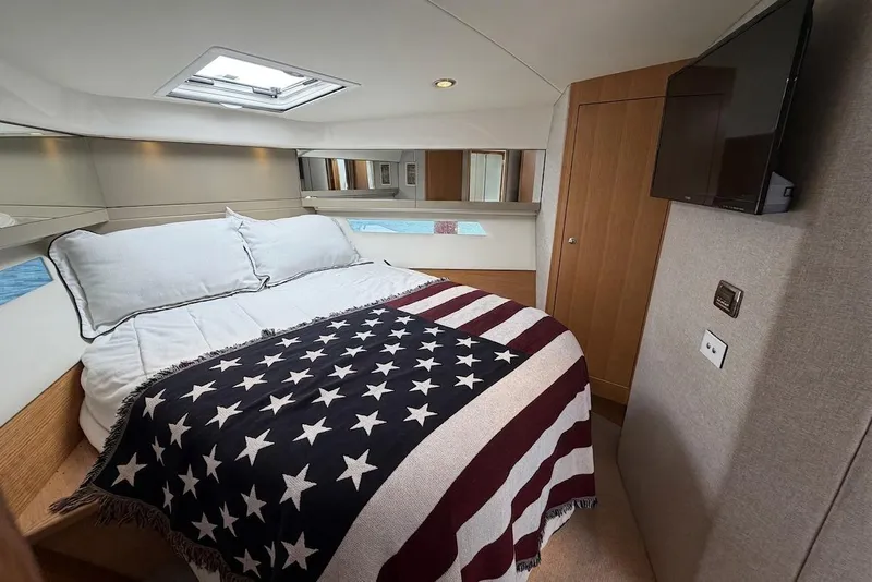 Slide: The Image of Luxurious bedroom in 2015 Riviera 445 SUV yacht with American flag blanket. - 20