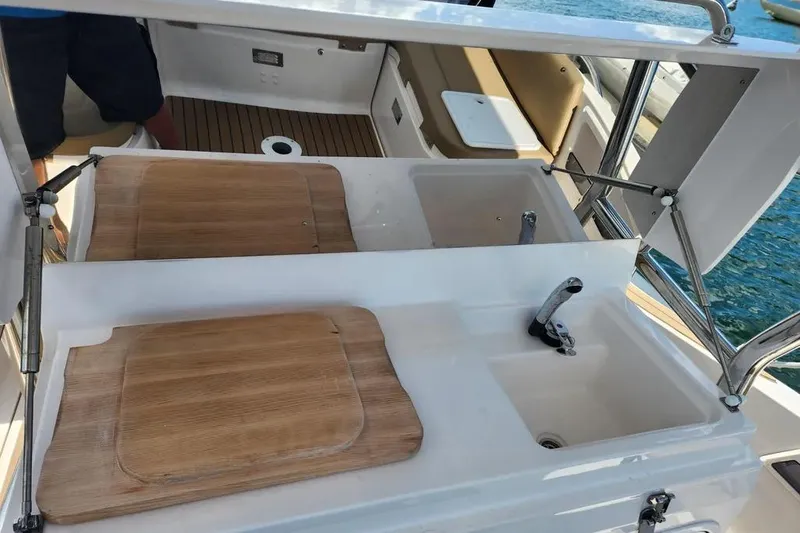 Slide: The Image of Zar Formenti 85 SL 2020 boat kitchen area with sink and wooden covers. - 10