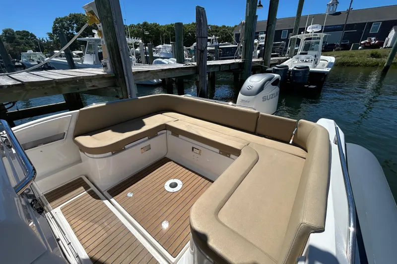 Slide: The Image of Zar Formenti 85 SL 2020 boat with tan seating and Suzuki outboard motor at dock. - 6