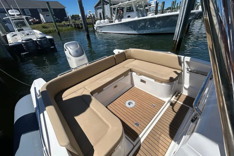 Slide: The Image of 2020 Zar Formenti 85 SL boat with beige seating and teak flooring at a marina. - 8
