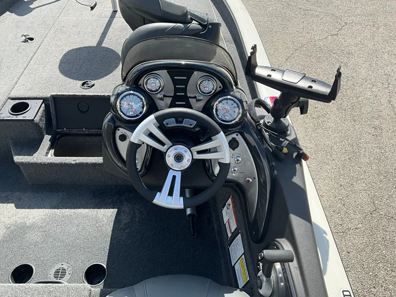 Slide: The Image of The image shows the cockpit of a Tracker boat with a modern steering wheel and instruments. - 8