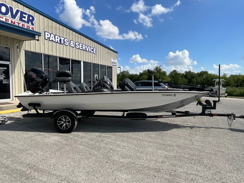 Slide: The Image of A 2023 Tracker boat on a trailer in front of a service center. - 4