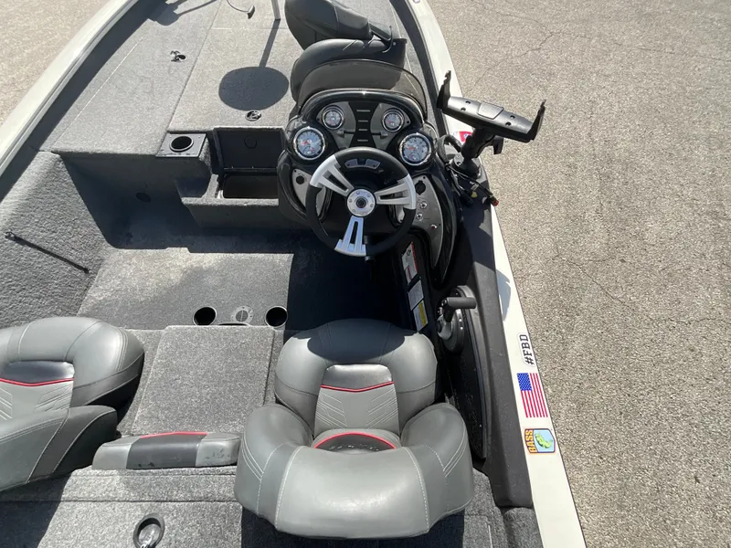 Slide: The Image of The image shows the cockpit of a 2023 Tracker boat with gray seats and a modern helm. - 7