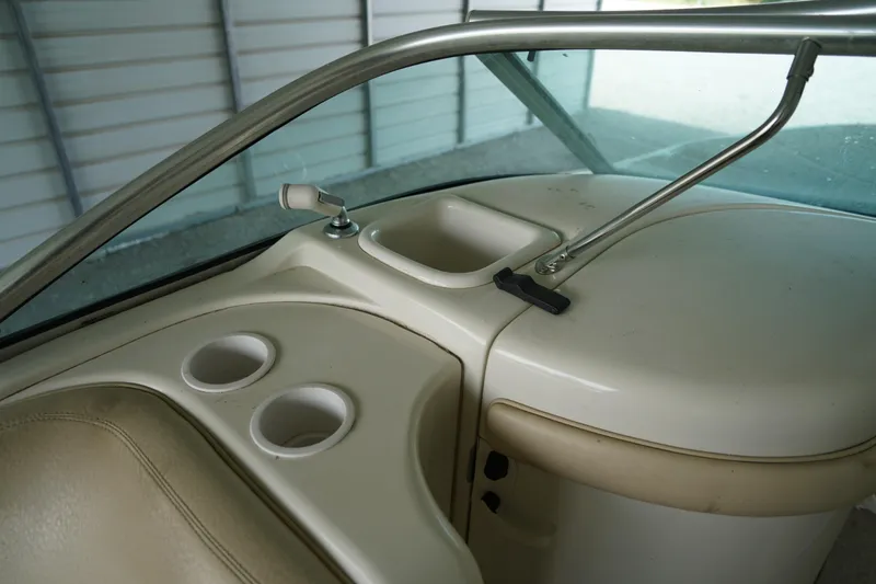 Slide: The Image of Interior view of a 2000 Sea Ray 210 Sundeck boat with cup holders and storage. - 13