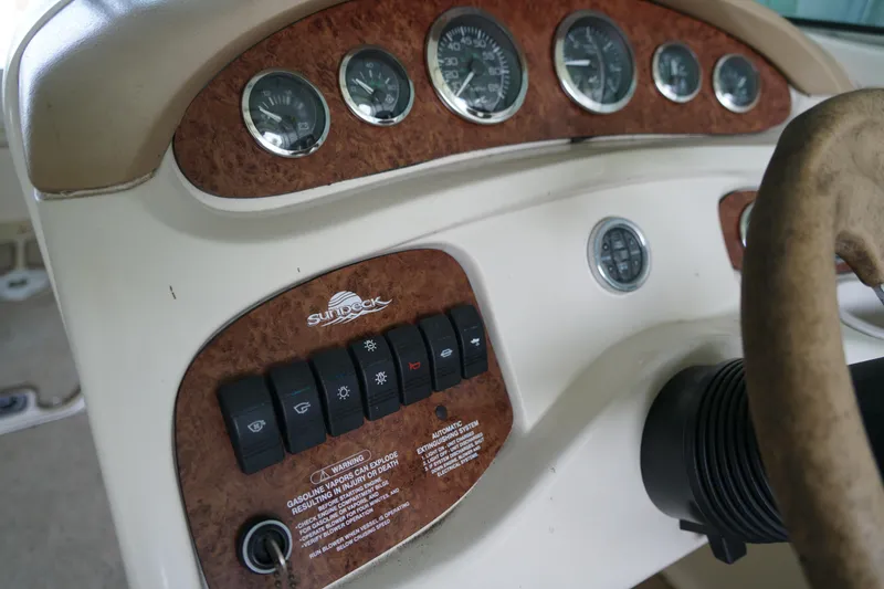 Slide: The Image of Dashboard of a 2000 Sea Ray 210 Sundeck boat with gauges and controls. - 10