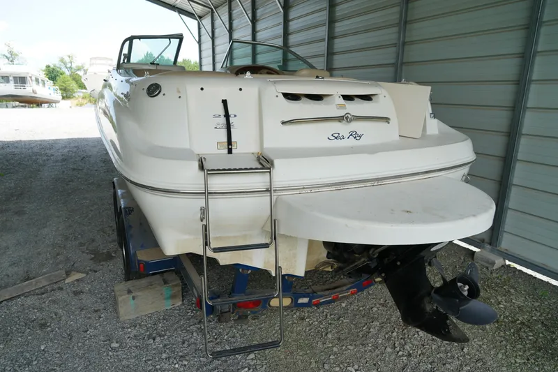 Slide: The Image of 2000 Sea Ray 210 Sundeck boat on trailer in covered storage area. - 6