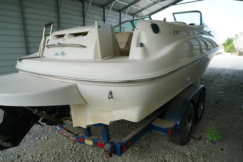 Slide: The Image of 2000 Sea Ray 210 Sundeck boat on trailer in covered storage area. - 4