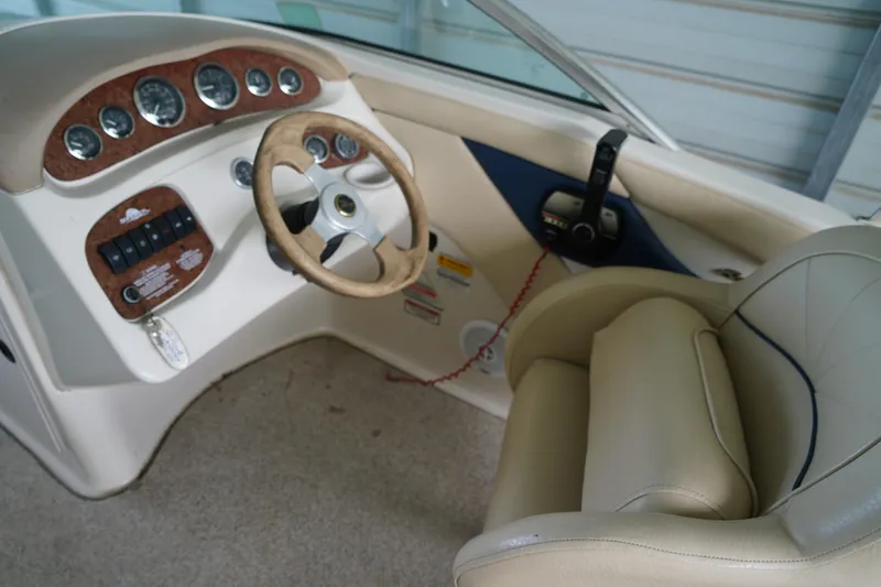 Slide: The Image of Interior view of a 2000 Sea Ray 210 Sundeck boat cockpit with steering wheel and controls. - 9