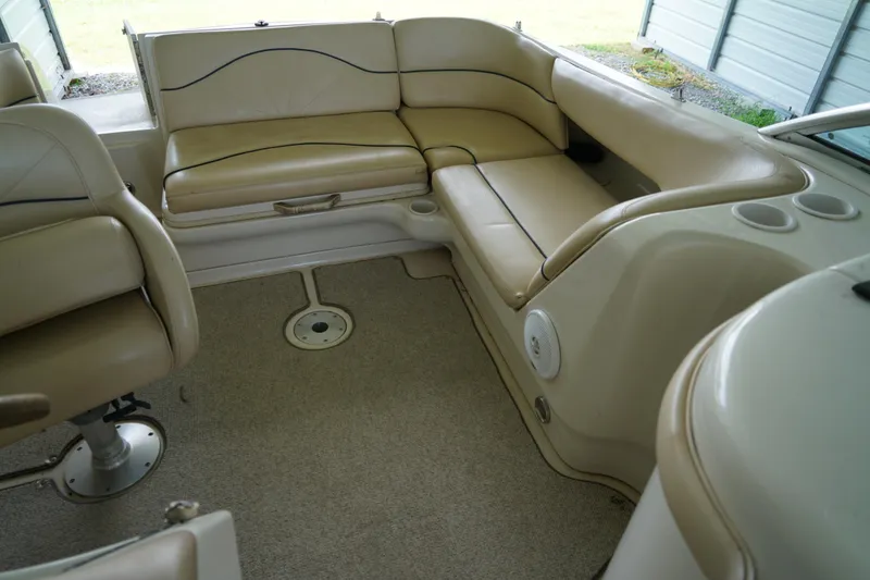 Slide: The Image of Interior of a 2000 Sea Ray 210 Sundeck boat with beige seating and carpet. - 12