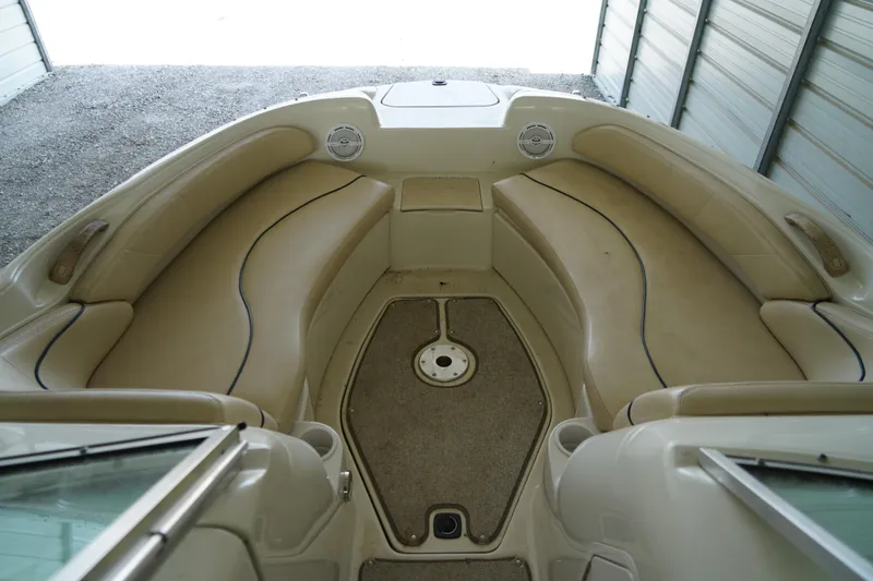 Slide: The Image of Interior view of a 2000 Sea Ray 210 Sundeck boat with beige seating. - 16